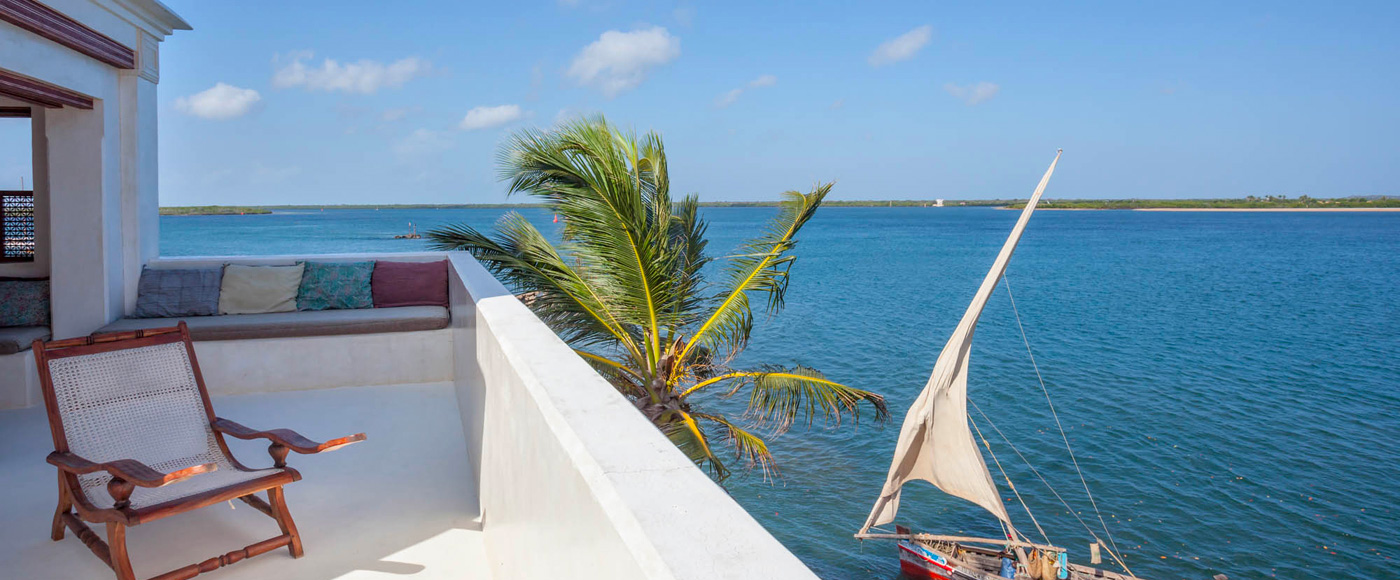 terrace of the villa in Shella Beach on Lamu Island in Kenya with ocean view and traditional boat